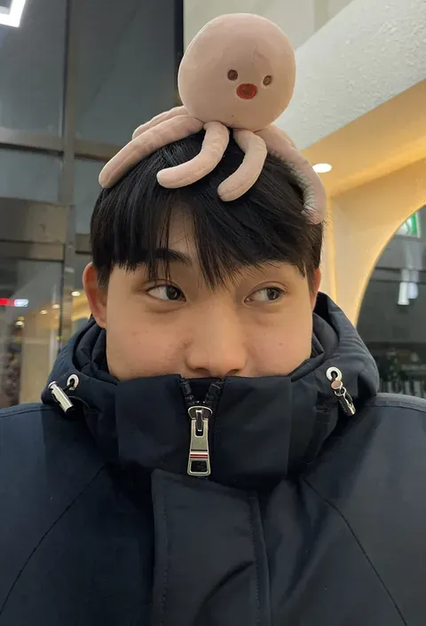 Taka wearing a plush octopus hat